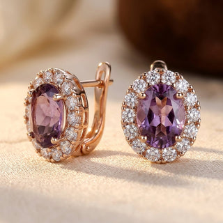 Gouden oorbellen met amethist en stralenkrans