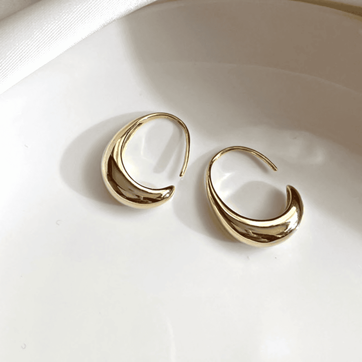 Ovale Creolen aus Gold und Silber
