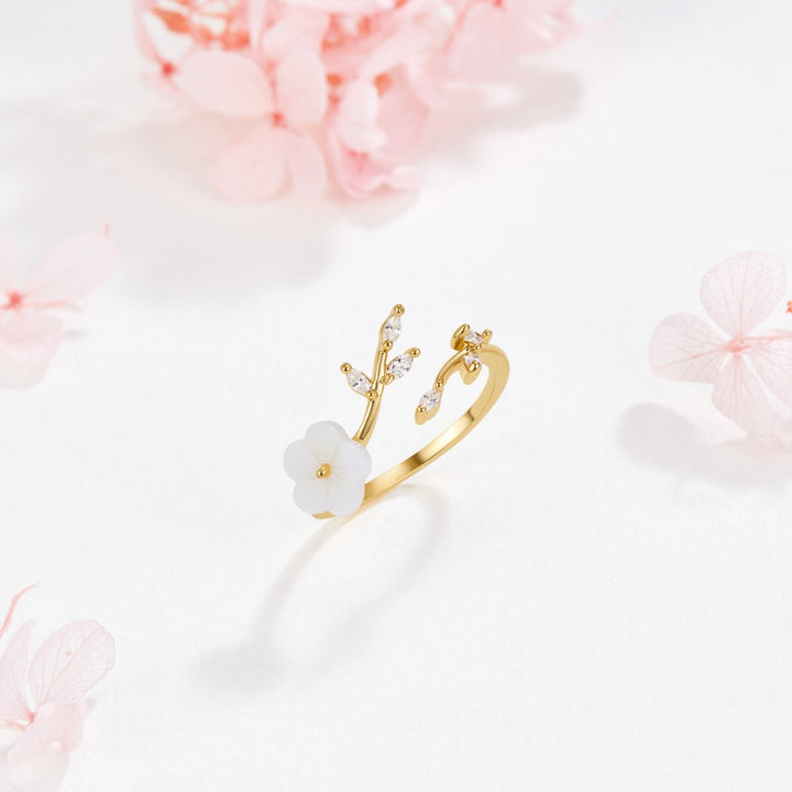 Gouden open ring met bloem en blad